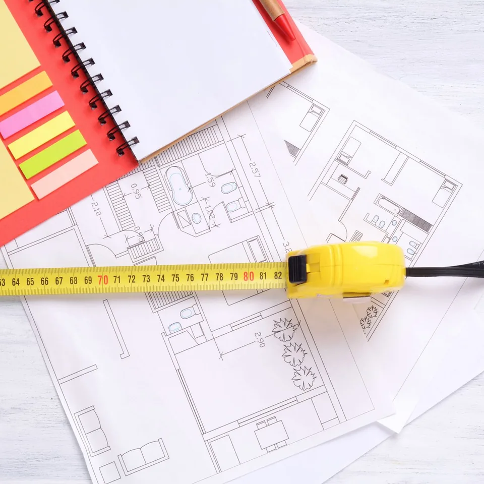 Plan de logement, carnet de notes et mètre ruban pour préparer les travaux